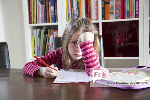 Frustrated girl doing homework