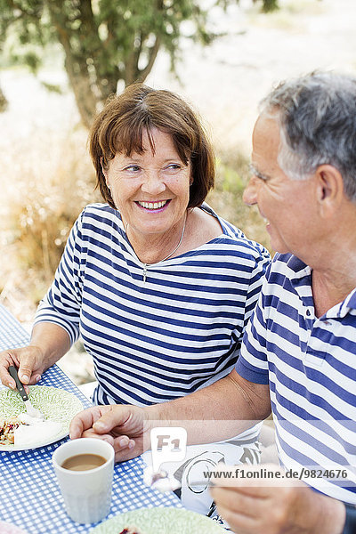 Mature couple having meal outdoor