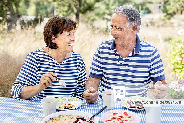 Mature couple having meal outdoor