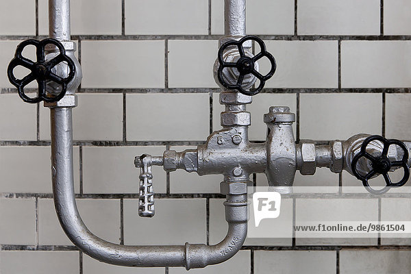 Old pipes and valves  tile wall