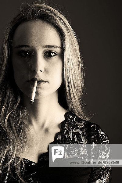 Portrait of a young woman with cigarette
