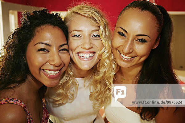 Close up of women smiling together