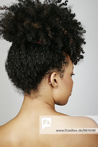 Rear view of mixed race woman looking over shoulder