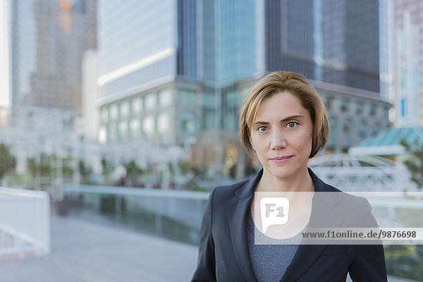 Caucasian businesswoman standing in city