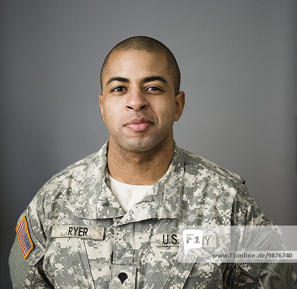 Close up of mixed race soldier smiling