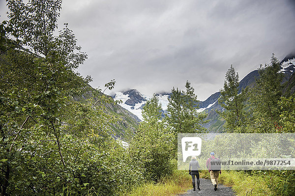 Couple walking on hiking path in Portage Valley  Southcentral Alaska