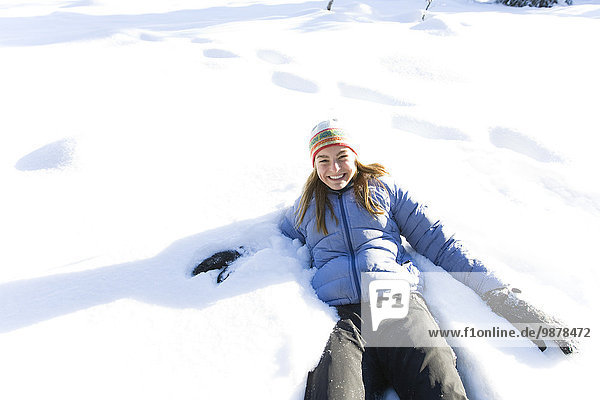 Young Woman On Snowshoes Plays In Snow Near Homer  Alaska During Winter.