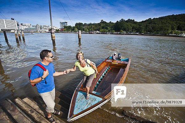 'A couple taking a river boat ride; Bandar Seri Begawan  Brunei'