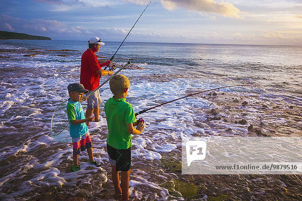'Father and sons fishing on Niue Island; Niue'