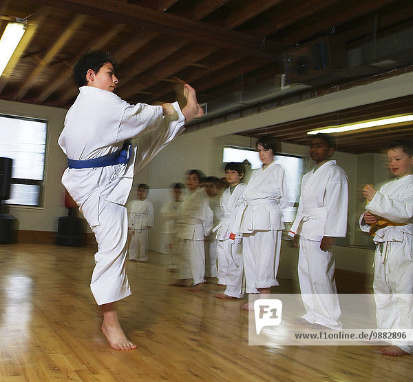 7-year-old boy demonstrating flying karate kick