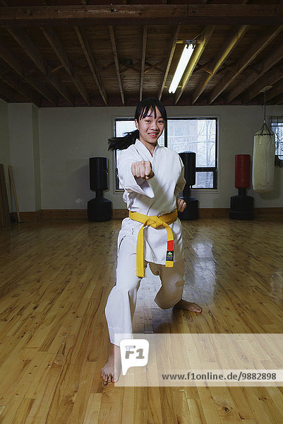 Girl in karate class demonstrating karate stance