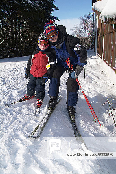 Mother And Son Skiing.