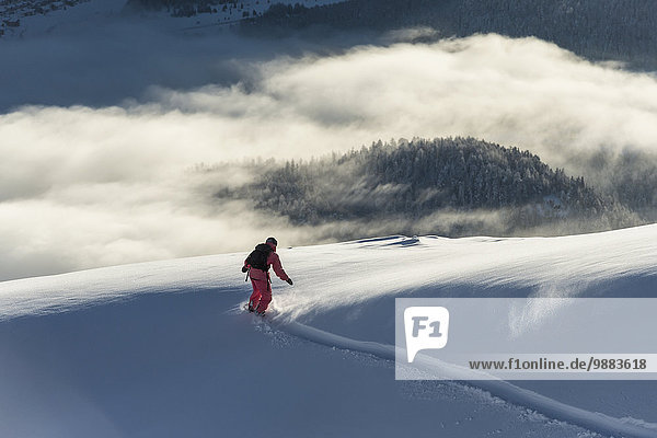 Snowboarding Wolke über Kanton Graubünden