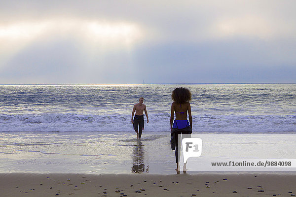 Young woman waiting for surfing boyfriend on beach  Playa Del Rey  California  USA