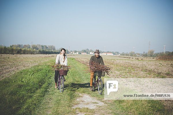 Young couple cycling in countryside  Dolo  Venice  Italy