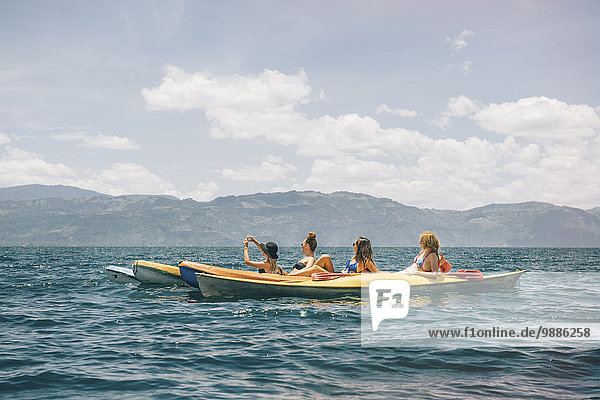 Four young female friends kayaking on Lake Atitlan  Guatemala