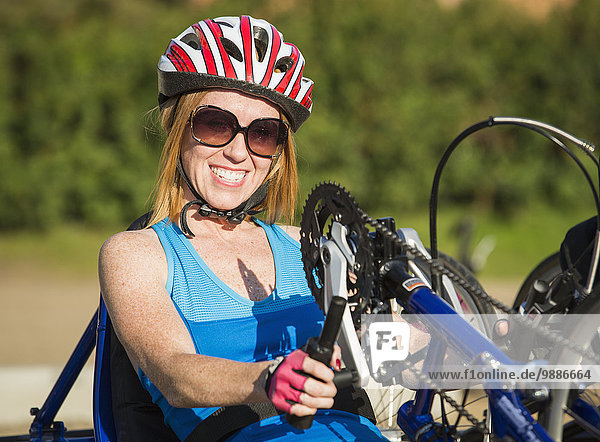 Woman with spinal cord injury cycling using hand propelled bicycle; Edmonton  Alberta  Canada
