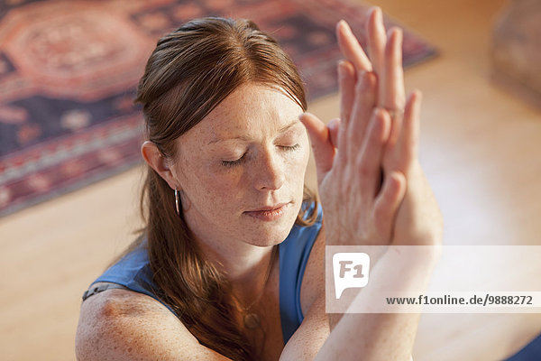 Woman practices yoga at indoor studio
