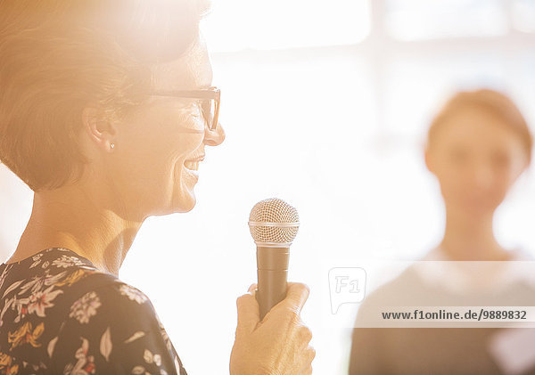Close up woman speaking with microphone