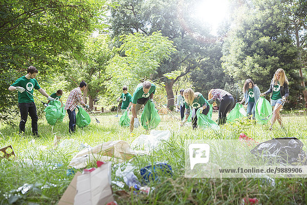 Freiwillige Umweltschützer sammeln Müll auf dem Feld ein