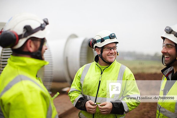 Engineers having conversation at wind farm