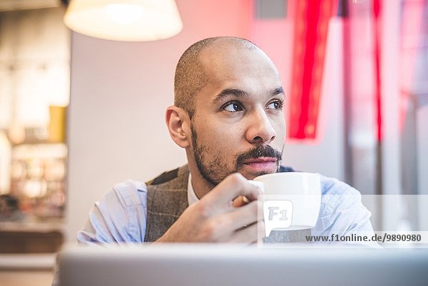 Businessman sitting in cafe drinking coffee