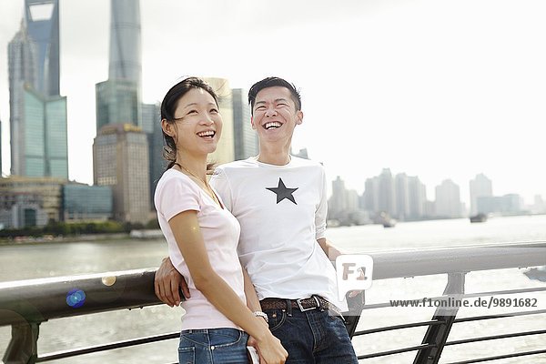 Tourist couple leaning against bridge railing  The Bund  Shanghai  China