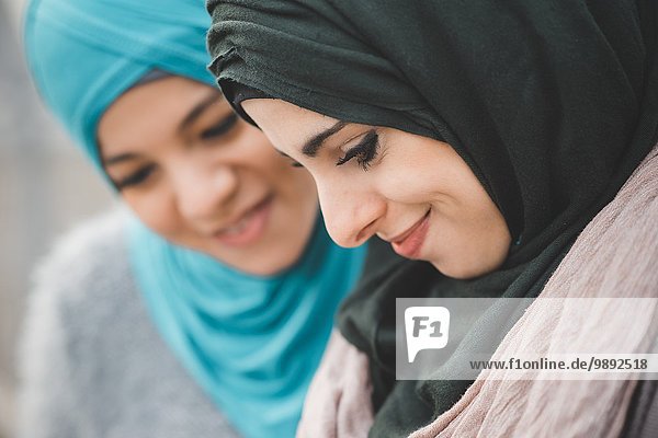 Close up of two young women wearing hijabs