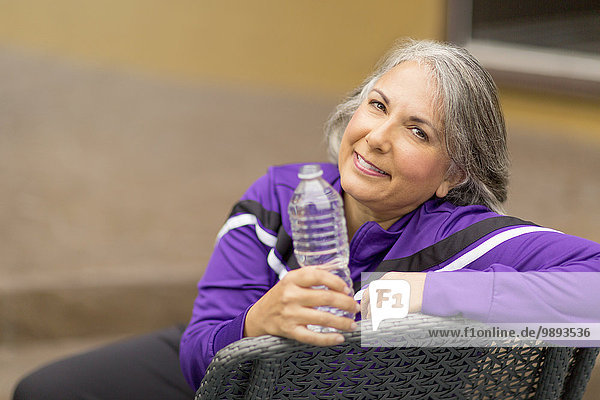 Portrait of mature woman holding water bottle