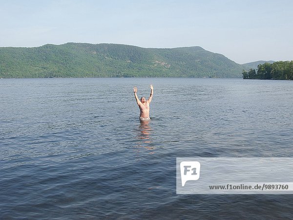 A man celebrating summer in Lake George  New York  USA