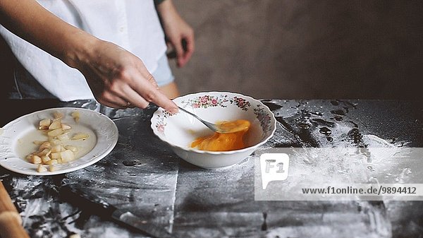 Woman's Hand Beating Egg in Bowl with Fork