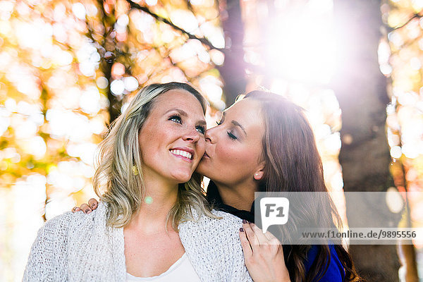 Woman kissing her female friend