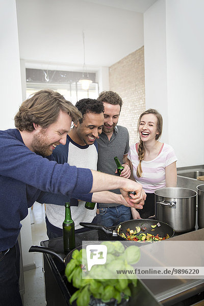 Happy friends cooking together