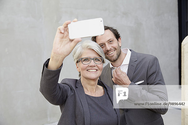Businesswoman taking a selfie with smartphone