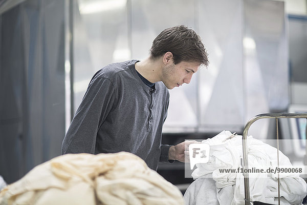 Worker in laundry looking at note