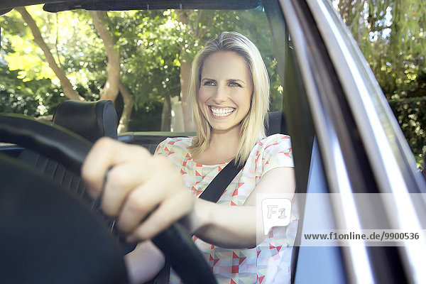 Blonde woman driving in covertible