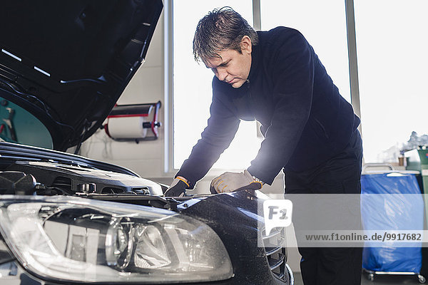 Mechanic repairing car in auto repair shop