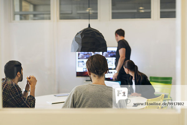 Creative business people preparing foe video conference in board room