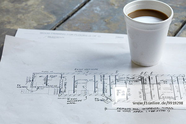 Home Renovation Still Life with Blueprint and Styrofoam Coffee Cup
