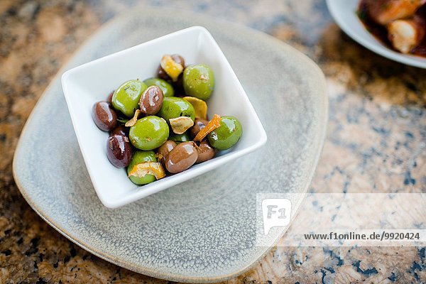 Schale mit schwarzen und grünen Oliven auf dem Restauranttisch