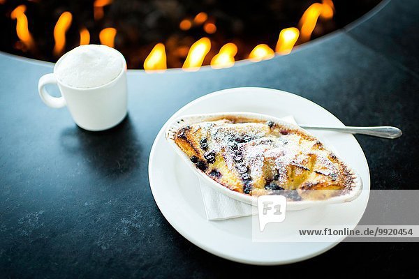 Pudding and coffee by restaurant open fire