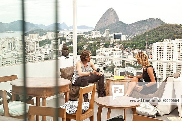 Young couple chatting on rooftop terrace  Rio De Janeiro  Brazil