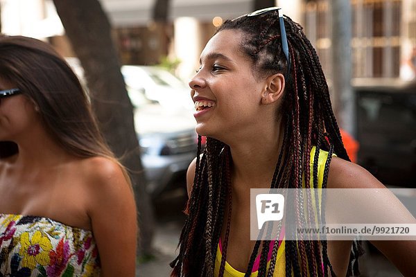 Two young women chatting on street  Copacabana town  Rio De Janeiro  Brazil