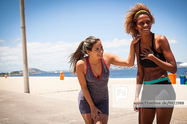 Young women laughing on beach