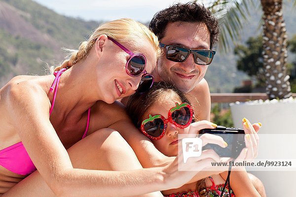 Young family taking self portrait with camera
