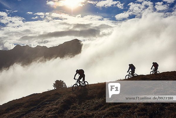 Three people mountain biking  Valais  Switzerland