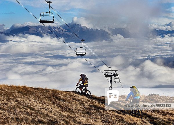 Zwei Mountainbiker unter den Seilbahnen  Wallis  Schweiz