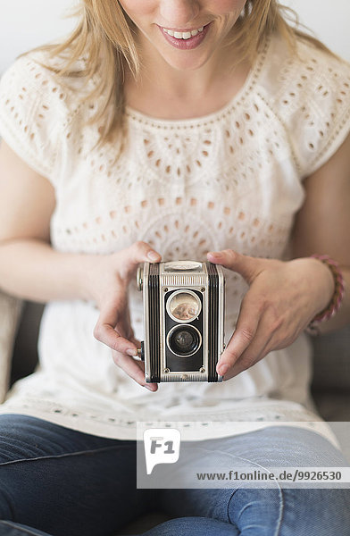 Woman using antique camera