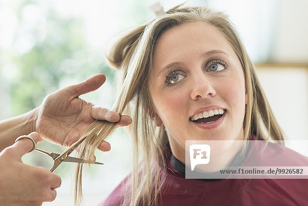 Woman getting haircut