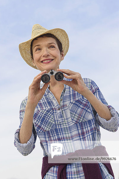Smiling senior woman with binoculars